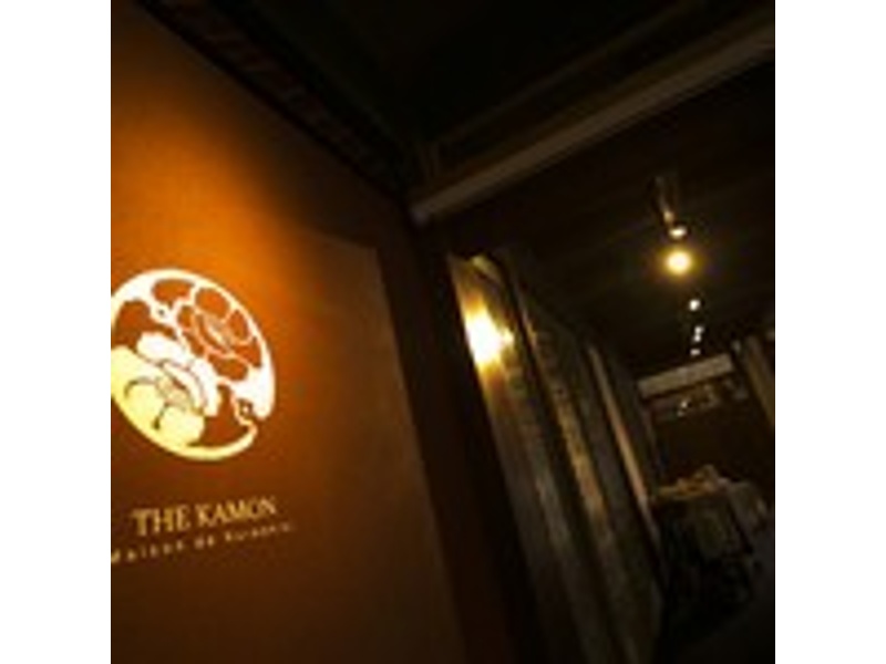 暖かな灯りに浮かぶThe華紋の看板。倉敷美観地区に佇む、非日常へと誘う入口です。